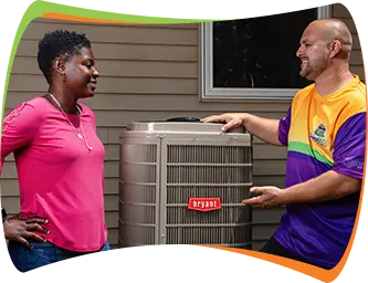 a man and woman standing next to a heat pump